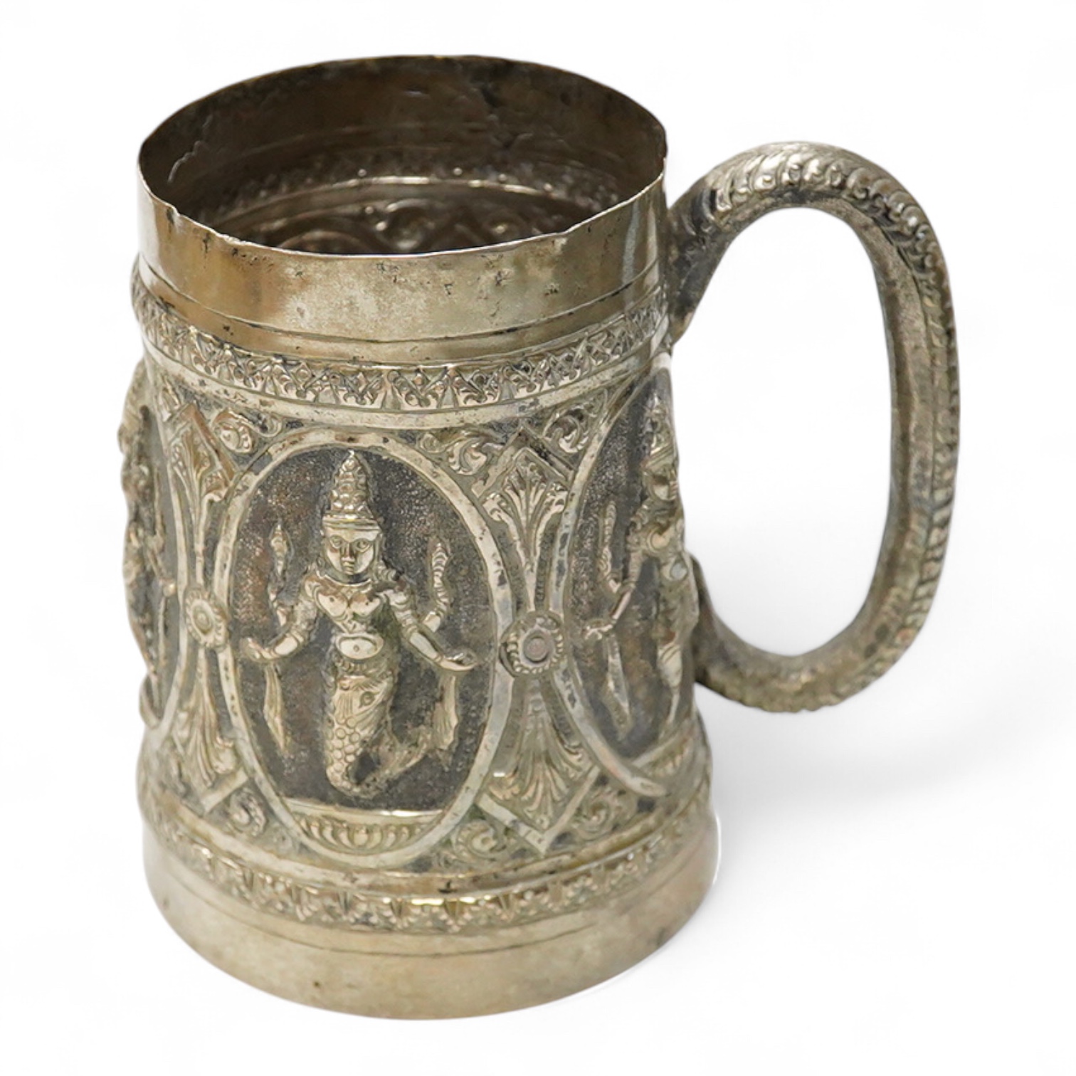 A 19th Century Indian white metal mug, embossed with deities, 11.1cm.